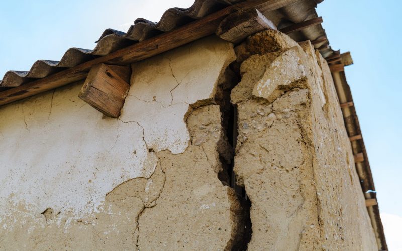 A large dangerous crack in the wall of the house. Destroying the house, the alarm state. Closeup, cracked